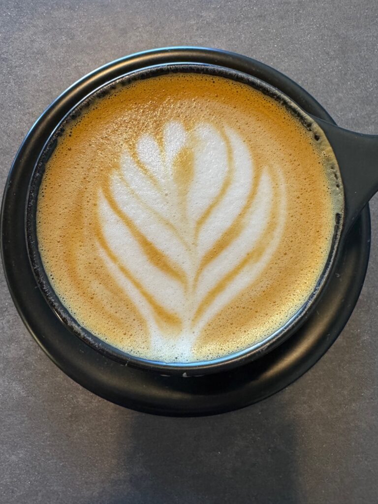 A Cup of Kingdom Coffee Roaster Cappuccino with perfect latte art.