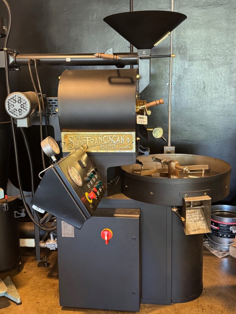 An image of Kingdom Coffee Roaster  machine in the corner of the shop.